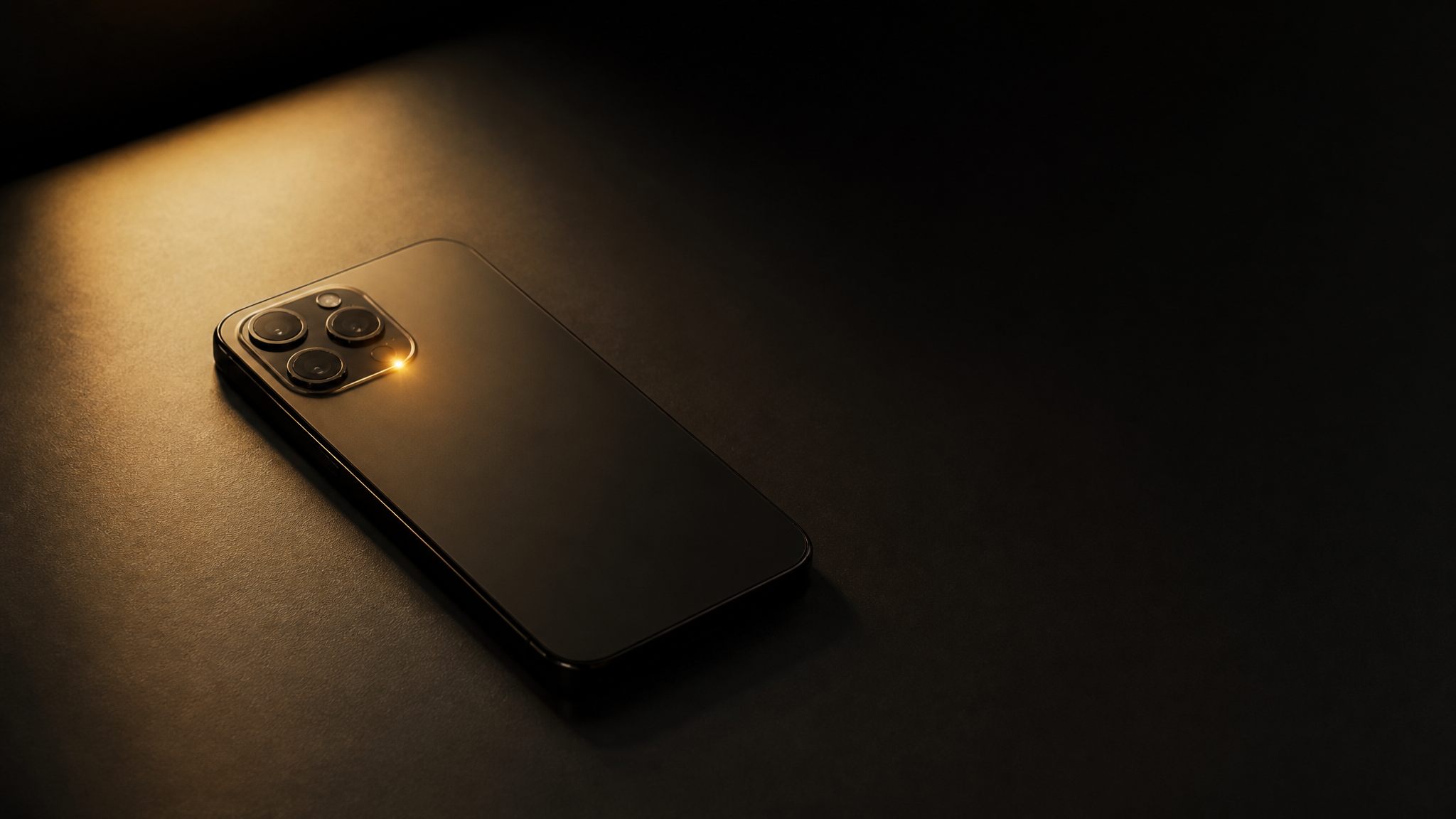 Dark smartphone face-down on a matte surface with a single gold notification light glowing